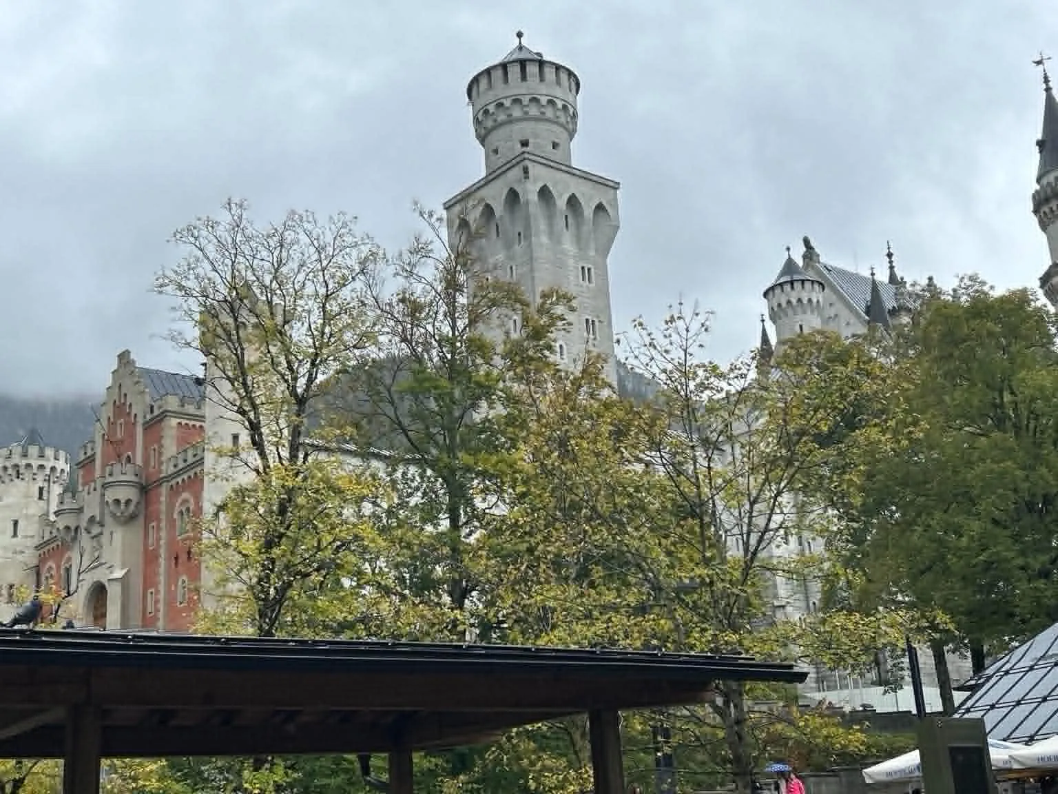 Neuschwanstein Castle rising above autumn trees in Germany